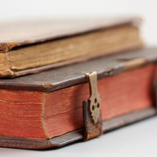 Two old books stacked on top of each other.