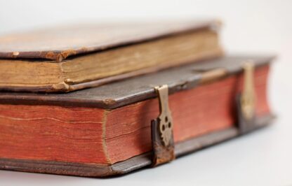 Two old books stacked on top of each other.