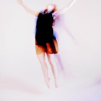 Picture of woman leaping in the air. The image is over exposed and dramatic in style.