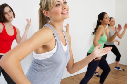 Women dancing in a gym class.