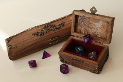 Two wooden chests - one open, one closed - display colourful multi-sided dice for Dungeons and Dragons.