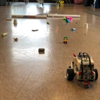 Wheeled robot vehicle made with Lego at the beginning of an obstacle course.