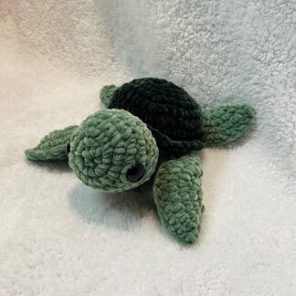 A crocheted sea turtle on a white background.
