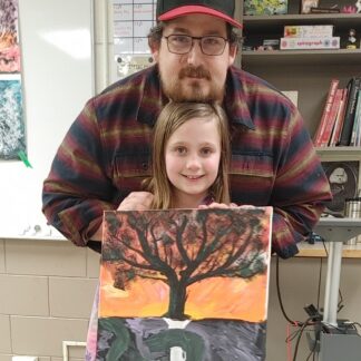 Father and child hold a painting together