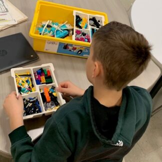 A child works with Lego