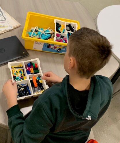 A child works with Lego