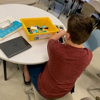 A child works with Lego