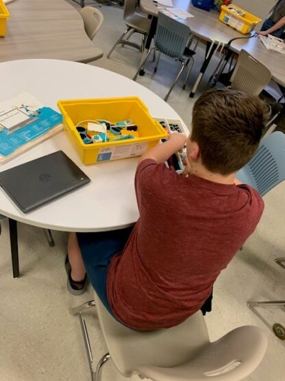 A child works with Lego