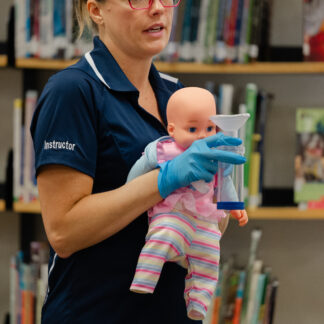 instructor holds a baby doll