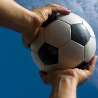 Hands holding a soccer ball