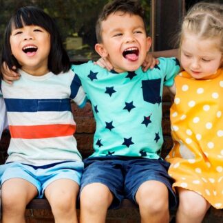 children sitting next to each other laughing