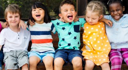 children sitting next to each other laughing