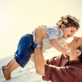 Father holds child in the air