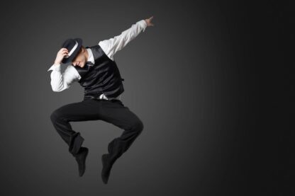 Man wearing hat and vest jumps in the air