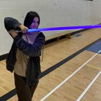 Girl holds purple lightsaber