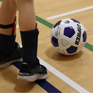 Feet prepare to kick soccer ball