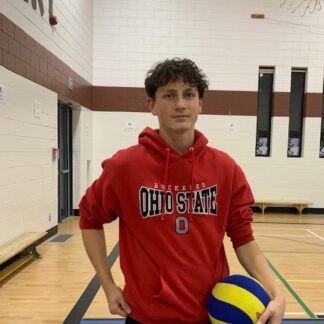 Boy stands with volleyball