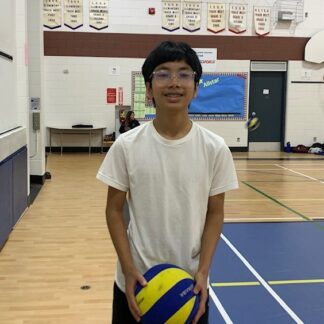 boy holds volleyball