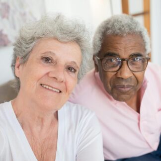 older couple smiles at camera.